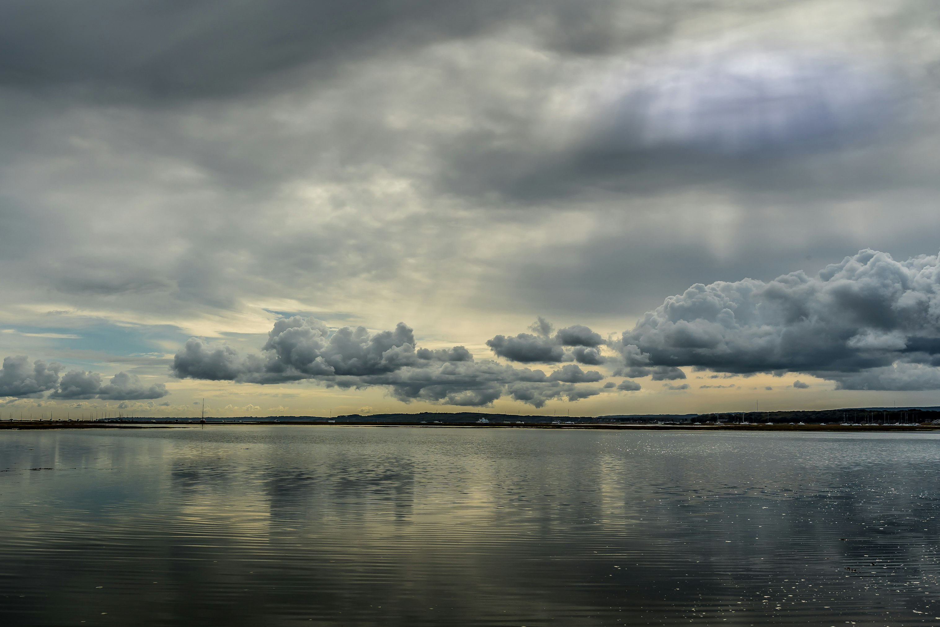 body of water under cloudy sky during daytime